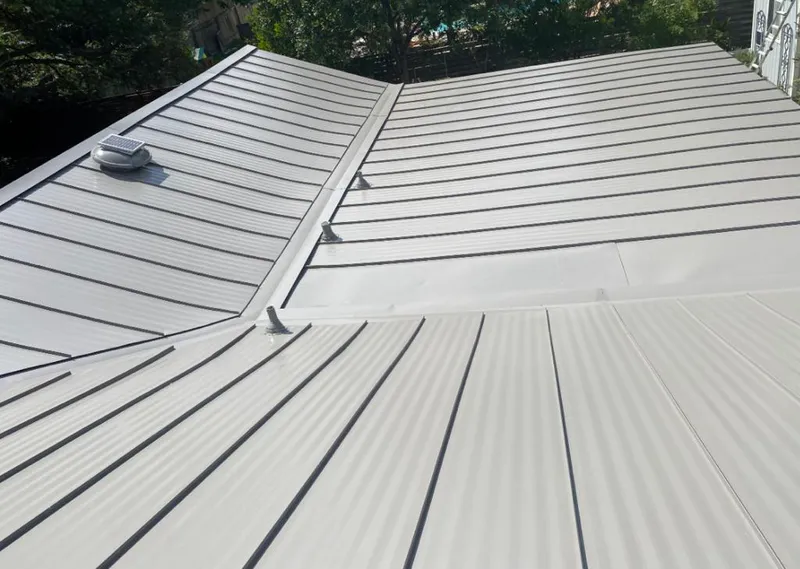 Solar attic fan installed on a metal roof for Roof Ventilation in Rapho